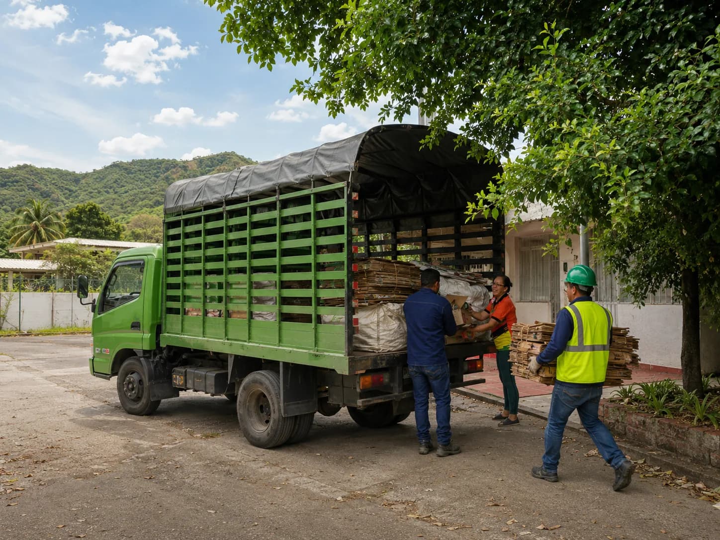 Recollector truck picking up recyclable materials from a business. Daylight photo.